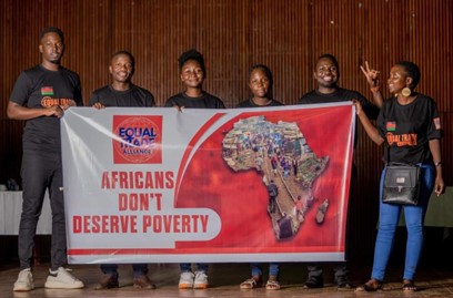 The ETA team holding a poster that says "Africans don't deserve poverty"